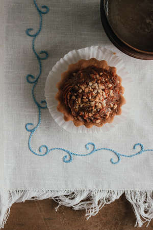 Shortcake baskets with walnuts and condensed milk. Russian style. Homemade baking on a white napkin. Dessert - biscuits with coffee cappuccinoの写真素材