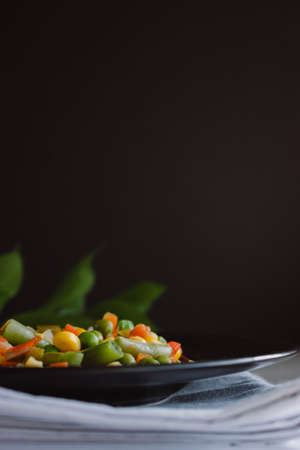 Frozen fried vegetables on black plateの写真素材
