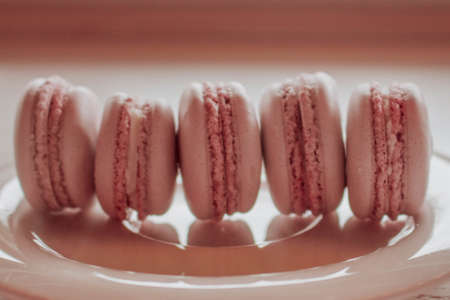 Strawberry macarons closeup. Fresh and colourful on pink backgroundの写真素材