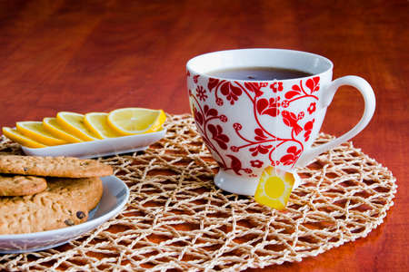 Tea with biscuits prepared on a wooden table.の写真素材