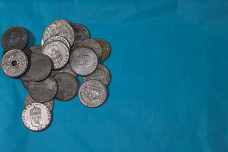 A stack of silver coins on a blue backgroundの写真素材