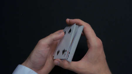 Poker game - shuffling cards. Mans hands shuffing cards. Close up. Mans hands shuffling playing...