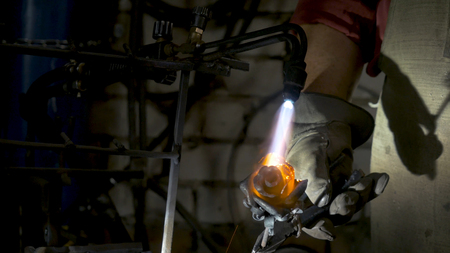 Blacksmith makes an iron rose. Man makes a rose out of ironの写真素材