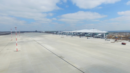 Aerial view of the modern international airport terminal. Traveling around the world. Empty airport aerial. View of runway at the airport. Airfield marking on taxiway is heading to runwayの写真素材