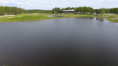 Aerial view on golf course with gorgeous green and pondの写真素材