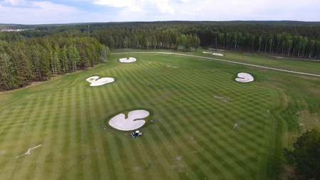 Top view green golf course outdoor green grass field. Aerial view from flying drone.の写真素材