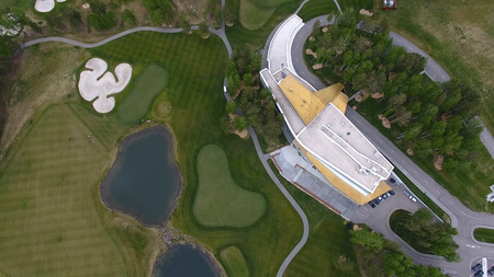 Solar Golf cart with clouds on blue sky and forest lake Golf club, aerial.の写真素材