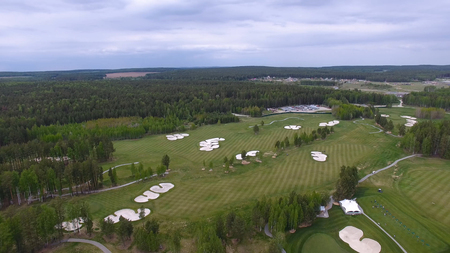 Solar Golf cart with clouds on blue sky and forest lake Golf club, aerial.の写真素材