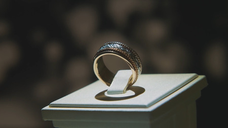 Precious diamond rings. Fine luxury diamond jewellery window display with ring pedant. Gold ring with brilliant isolated on black backgroundの写真素材
