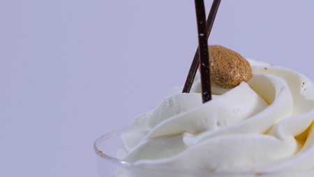Vanilla sundae ice cream in cup on background. Ice cream in a glass with cream, closeupの写真素材
