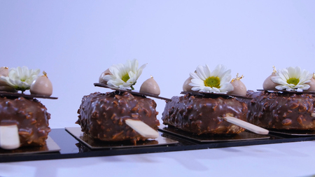 Ice cream covered with chocolate. Chocolate ice cream on a stick. Chocolate ice cream on a stick decorated with flowersの写真素材
