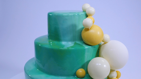 Stylish mousse cake with turquoise mirror glaze. Cake with turquoise mirror glaze decorated with chocolate balls.の写真素材