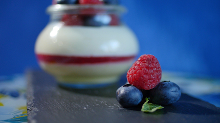 Homemade yogurt with blueberries in a glass jar. Strawberry in Yogurt, close upの写真素材