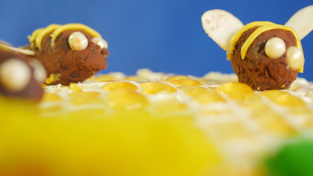 Beautiful honey cake decorated with bees of cream. Beautiful honey cake, closeup.の写真素材