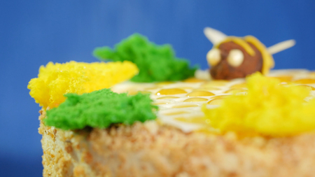 Beautiful honey cake decorated with bees of cream. Beautiful honey cake, closeup.の写真素材