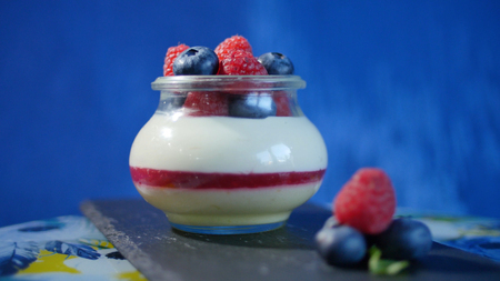 Homemade yogurt with blueberries in a glass jar. Strawberry in Yogurt, close upの写真素材