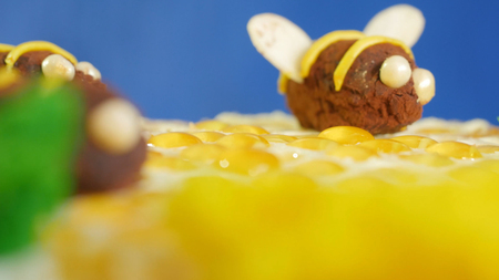 Beautiful honey cake decorated with bees of cream. Beautiful honey cake, closeup.の写真素材