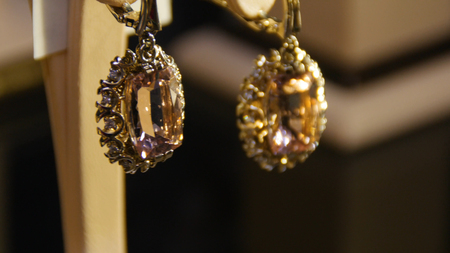 Golden earrings with gemstone. Earrings with precious stones.の写真素材