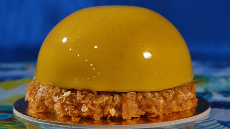 Delicious beautiful cake with yellow frosting. The mirror glaze on a cake round session. Mousse....