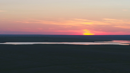 Aerial view of beautiful emerald green water lake and summer landscape sunset. Sunset on the lake.の写真素材