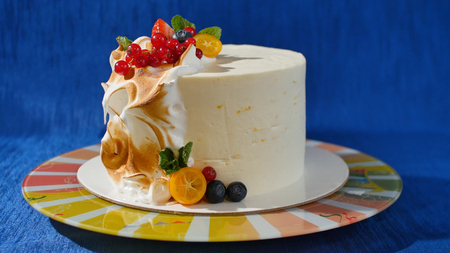 Traditional Christmas fruit cake with white frosting and sugared fruits. Cream cake with kumquat, cranberries, strawberries.の写真素材
