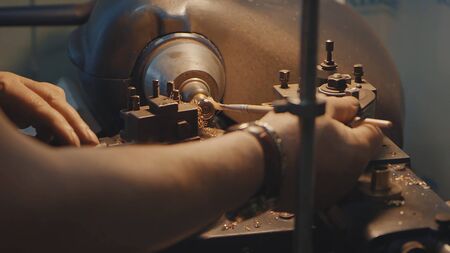 Production of rings. Jeweler working with wax model ring in his workshop. Craft jewelery making....