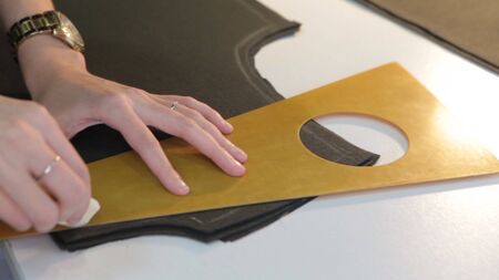 Tailor.Hands notch tailor tailors scissors cloth. Female tailor stitching material at workplace....