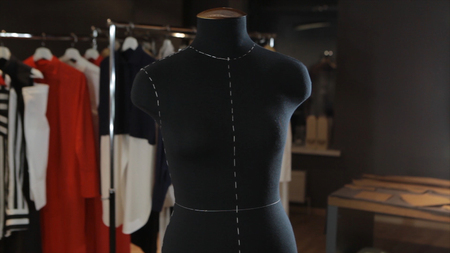 Empty black mannequin in the background light is in the middle of the studio. Cute toy in the form of dresses hanging on a rope. Shop Dummy. Fashion Designer Clothes Maker Draping Dummy In Studio. Mannequin Or Dressmakers Dummy On With Shopping Mall On Baの写真素材