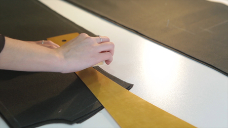 Tailor.Hands notch tailor tailors scissors cloth. Female tailor stitching material at workplace....