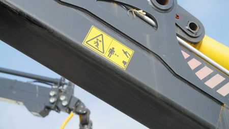 A forestry machine loads a log truck at the site landing. Forest machine down logsの写真素材