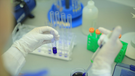 Test tubes closeup. Medical equipment. Close-up footage of a scientist using a micro pipette in a...
