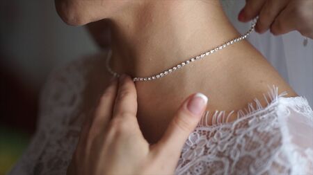 Wedding bracelet and necklace. Woman trying on jewelry bracelet. Bride with treasure. Woman with jewelry. Girl with fashionable jewelry, earrings, bracelets and necklaceの写真素材