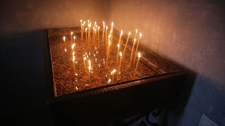 Lighting A Candle With A Match To Get A Romantic Candlelight. Amazing andles and candlesticks are on the table. Stay lights with the peaceful background of religious ceremony.の写真素材