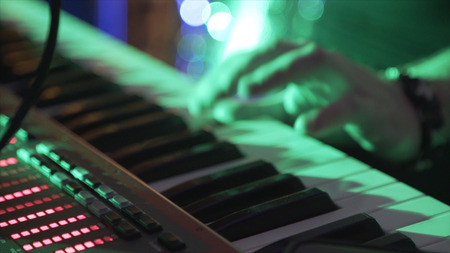 Closeup Of Male Hands Playing Piano. Man Playing The Synthesizer Keyboard. Man Plays Music Keyboard. Musician Plays Piano. A Musician Playing A Musical Instrument DJ plays the piano at the partyの写真素材