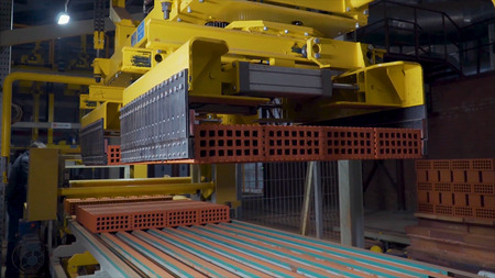 Plant for the production of bricks. Plant for production building material with ready brick, construction industrial. Production of bricks on plant. Workflow, close-up. Many bricksの写真素材