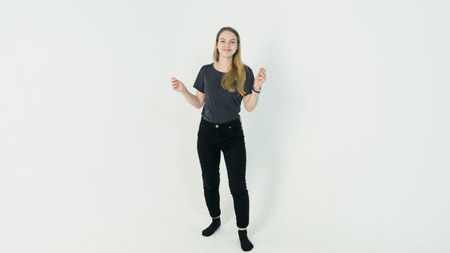 Happy dancing girl on white background. Young woman dancing on white backgroundの写真素材