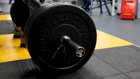 Close up view of barbell on floor in gym. Barbell falls to the floor after exercise. Barbell. Disassembled barbell on floor in gym HDの写真素材