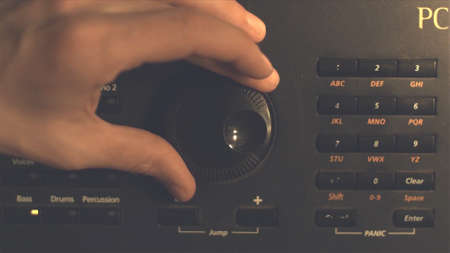 Hand tuning fm radio button. Retro image processed. Hand adjusting volume control. Broadcasting and...