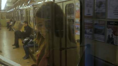 Beautiful girl reading a book in train at the subway. Teenager girl read a book in trainの写真素材