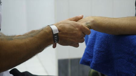 Boxing Trainer or Manager Wrapping Hands of a Boxer Close Up Shallow Depth of Field - Preparing For...