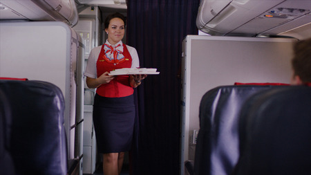 Stewardess Holding Tray With Airplane Meal. Air hostess carrying a tray of food. Stewardess brought lunchの写真素材