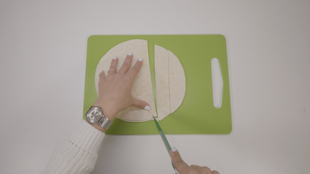 Womans hands cut the rolled dough by knife. Protection Symbol, heat comfortの写真素材