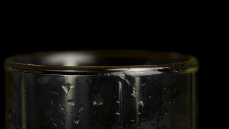 Crystal glasses. Close up on black background. Empty beer glass in the low-key lighting and surface reflectionの写真素材