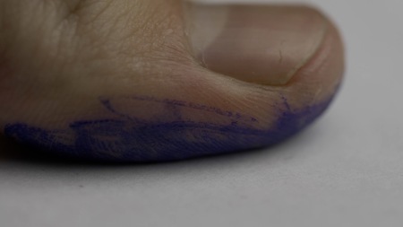 Fingerprint on police paper. Fingerprints of a male being taken in the police station. Close-up shot...