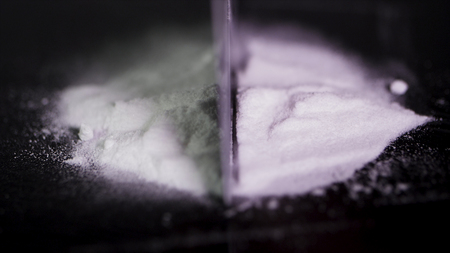drug use, people, addiction and substance abuse concept - close up of addict hands with crack cocaine drug dose track on mirror and credit card. The addict uses drugs, using a credit card.の写真素材