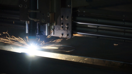 Laser cutter for manufacture. Clip. The laser cutter machine while cutting the sheet metal with the...