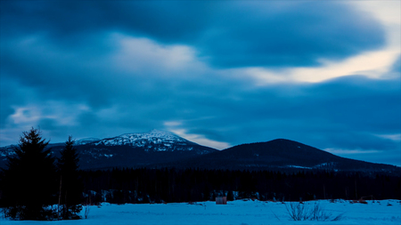 Snow peaks Mountains nature Background landscape Timelapse. Video. Clouds moving in Blu sky Panorama. Winter mountain at sunset over clouds in a valley. Sundown winter mountain, timelapseの写真素材