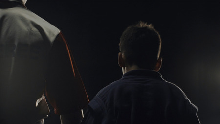 Rear view of the referee who raises the winners hand. The referee raises the hand of the boy winner in the ringの写真素材