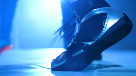 Young sporty man in the gym. Male boxer. Training. Mood, motivation, coach,sparring, competition - sport concept. View from the feetの写真素材