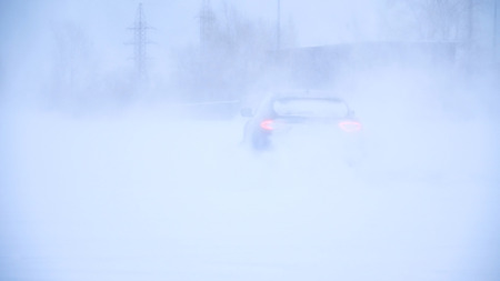 Sliding on an ice line. Snow drifting. snowy land road at winterの写真素材